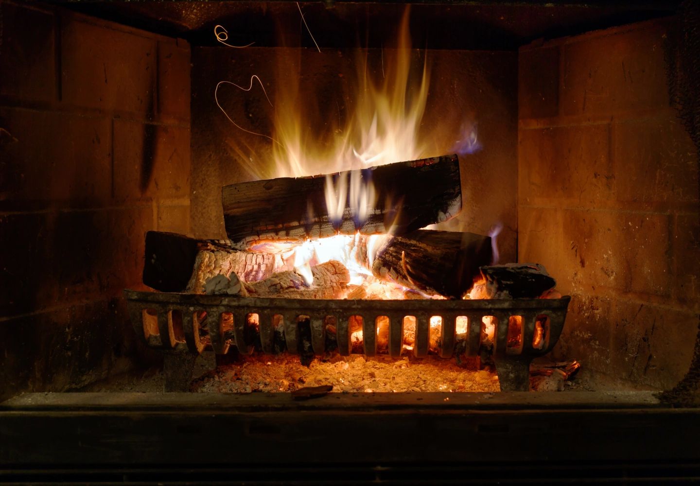 A glowing wood fire in a fireplace